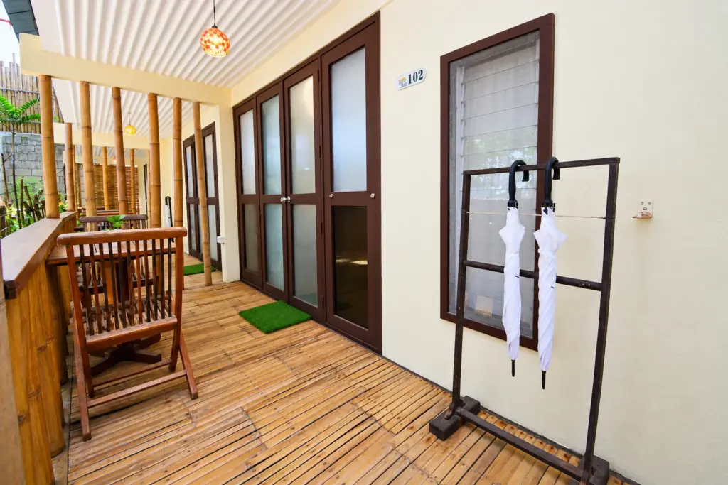 Bamboo deck and glass-paneled double doors of a Cottage