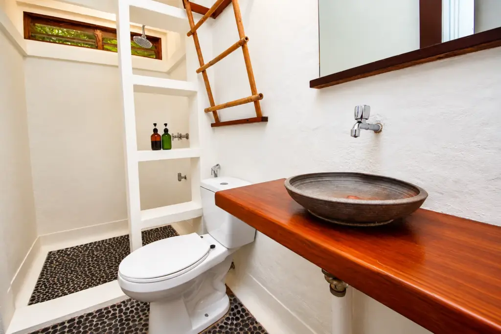 Bathroom with a wooden vanity, bowl sink and ladder towel rack