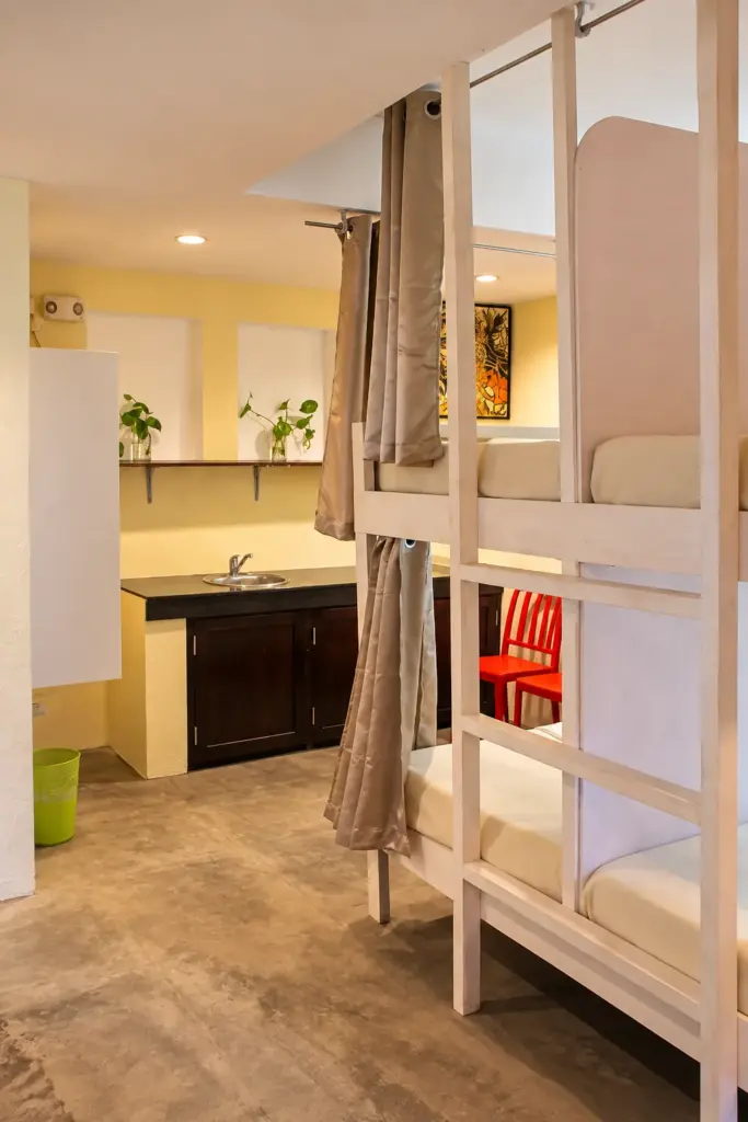 Bunk beds with privacy curtains and the kitchenette behind