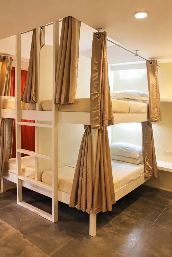 Bunk beds with privacy curtains in the 8-bed mixed dorm