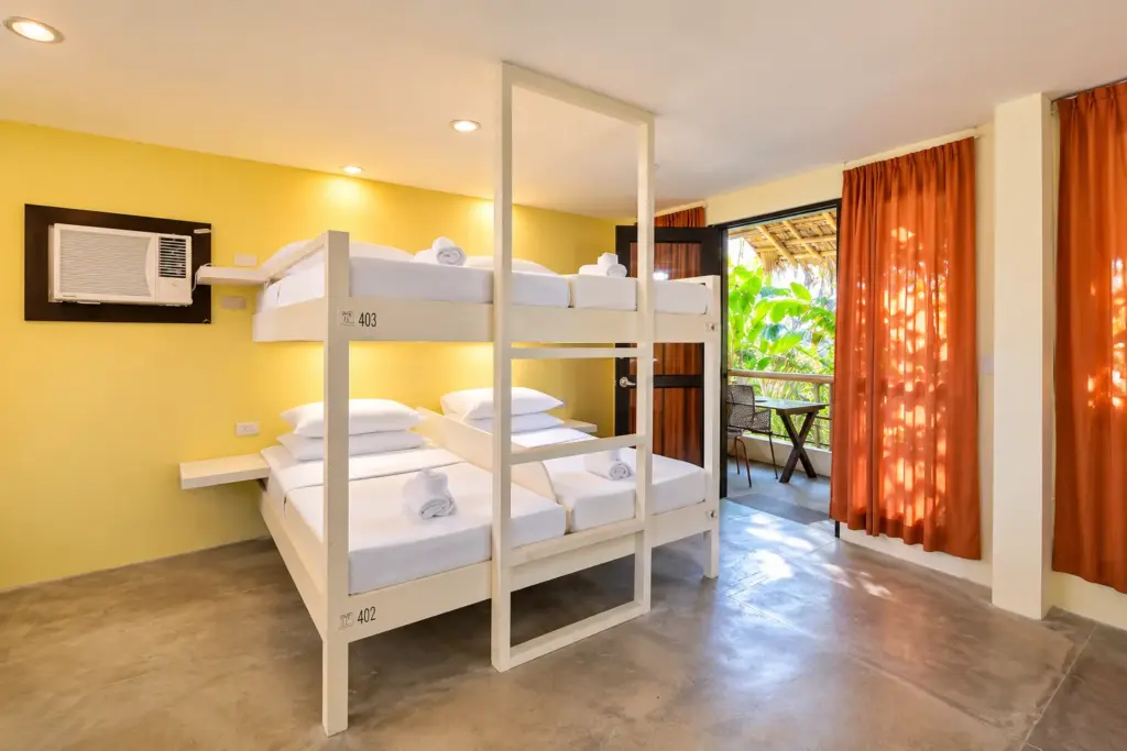 Dorm Room with bunk beds, orange curtains and air-conditioning