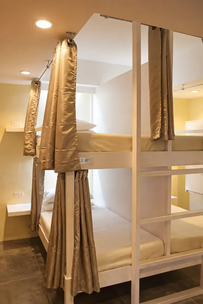 Bunk bed with a privacy curtain, reading light and fresh white linens
