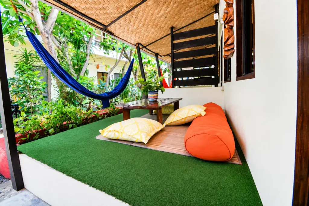 Family Room terrace with a hammock, orange floor cushion and low table