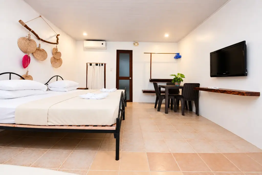 Family Room beds with a dining set and air-conditioning
