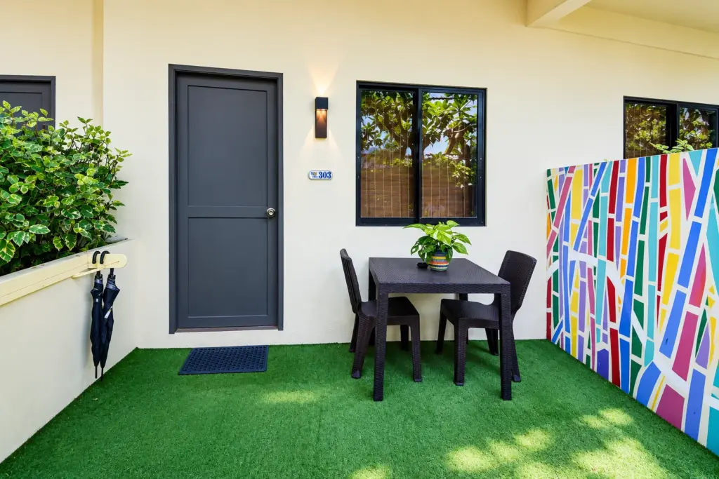 Entrance door and artificial-grass terrace of a Standard Queen