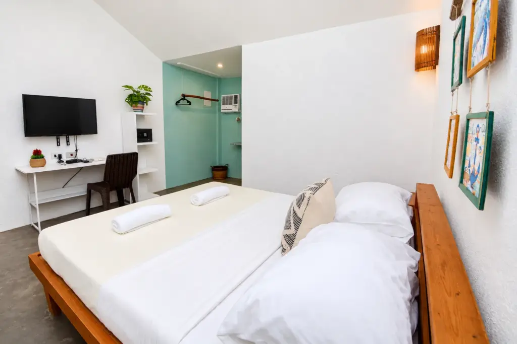 Queen bed with a writing desk and framed artwork