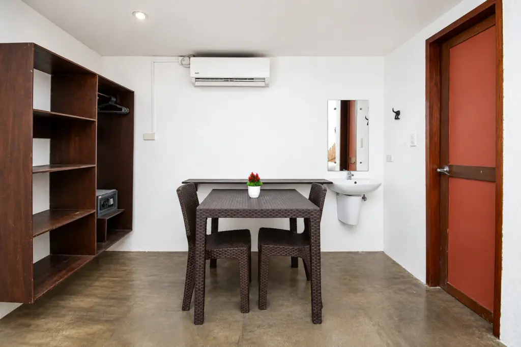 Dining table, wooden shelving and red door